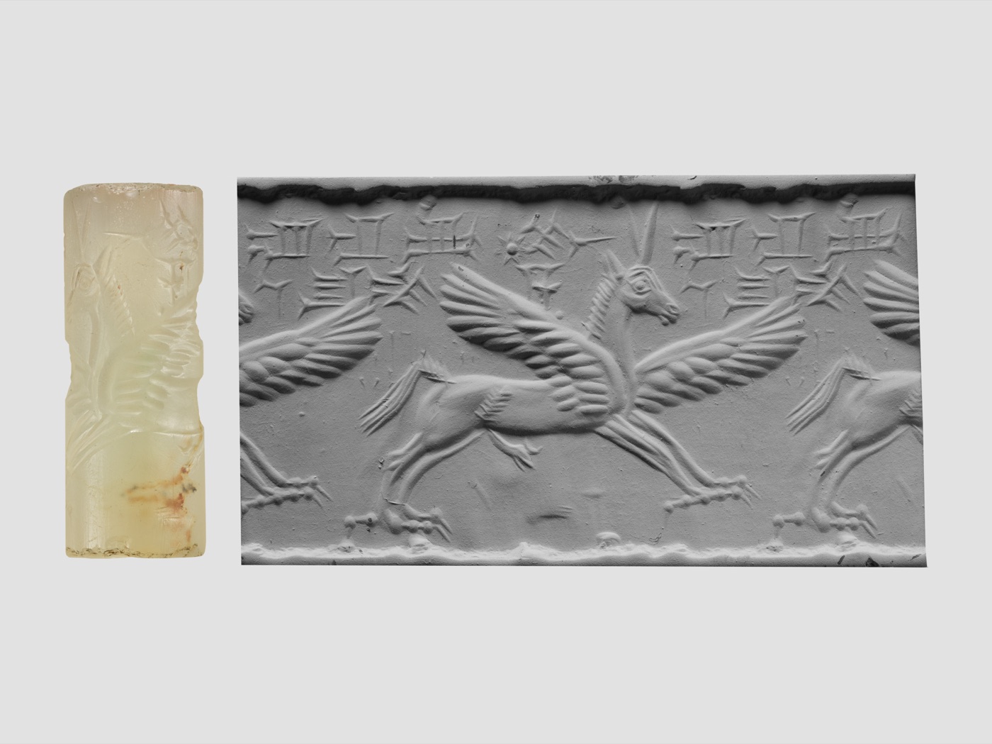 A chalcedony cylinder seal beside the impression it rolls: a winged horse and a cuneiform inscription
